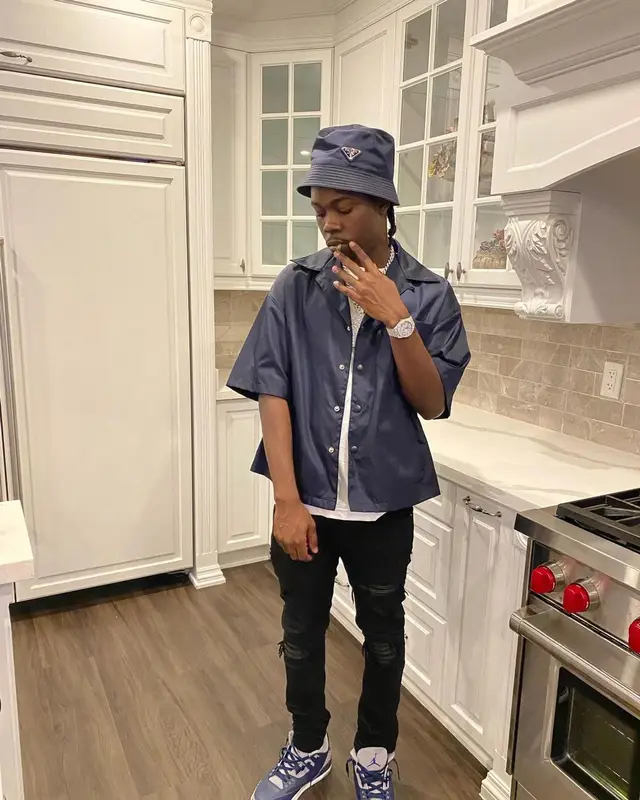 Burna Bandz outfit in Amiri, Jordan, and Prada, 2022