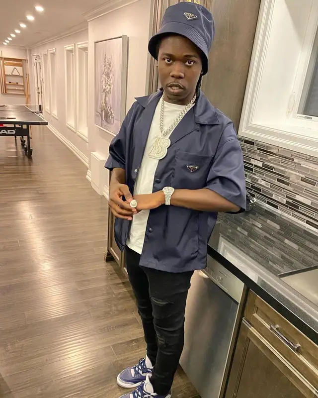 Burna Bandz outfit in Amiri, Jordan, and Prada, 2022