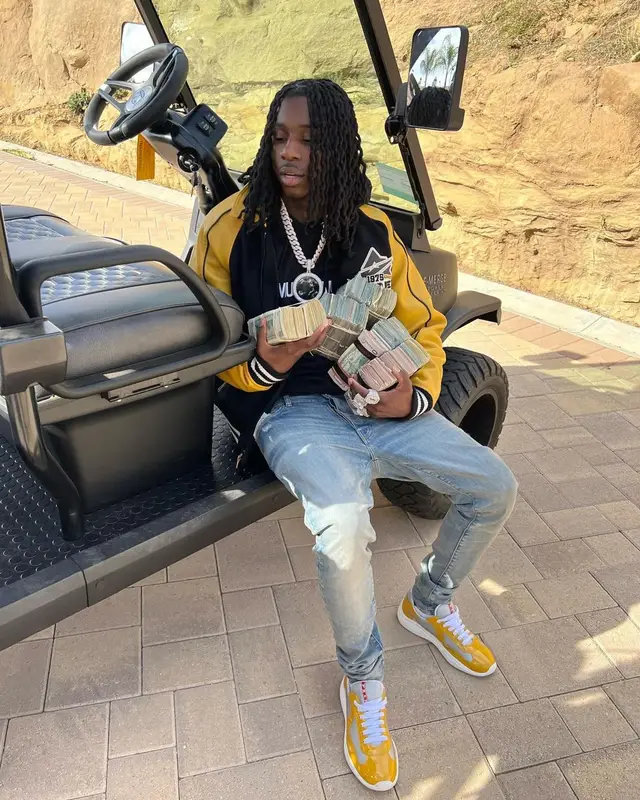 Polo G outfit in Avirex, Helmut Lang, and Amiri, 2022