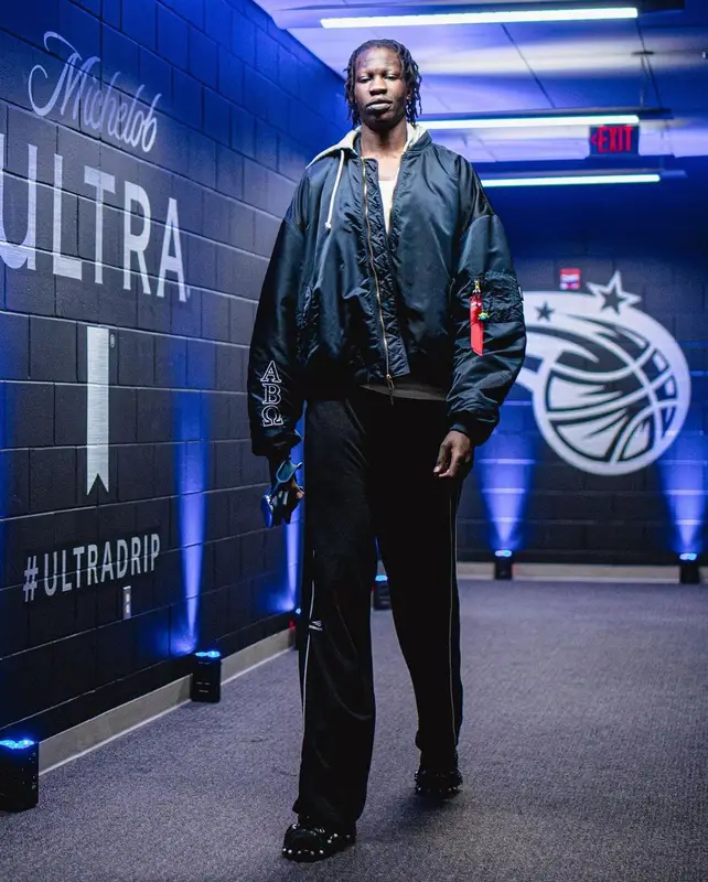 Bol Bol outfit in Vetements, Alpha Industries, and Apple, 2022