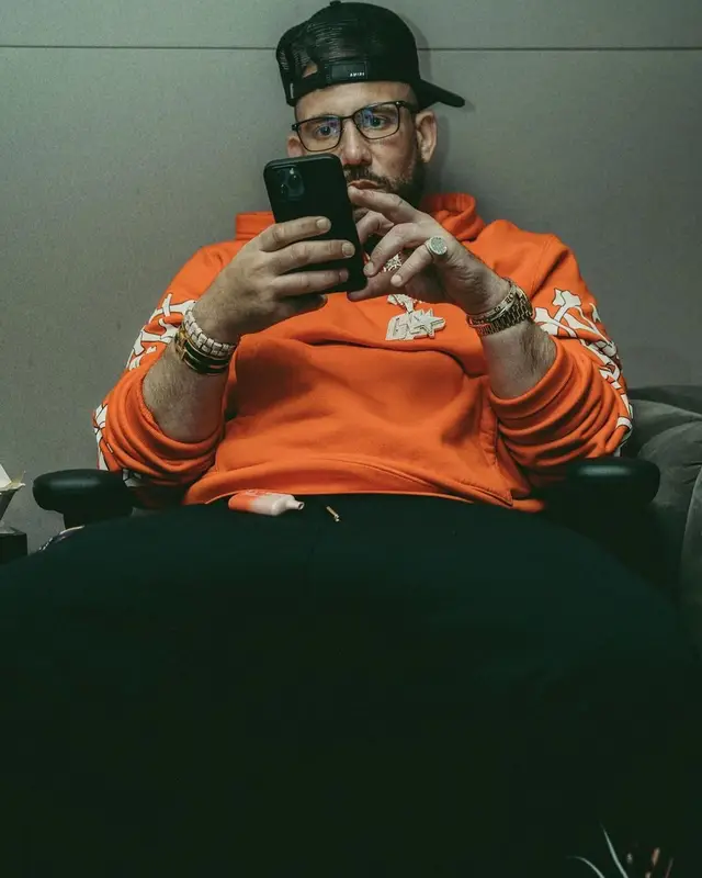 DJ Drama outfit in Thom Browne, Hermes, and Amiri, 2022