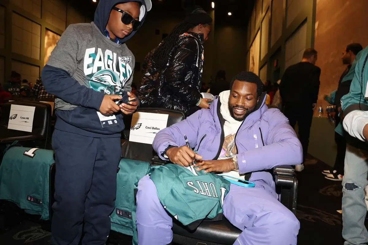 Meek Mill outfit in Dior, Jordan, and Descente, 2022