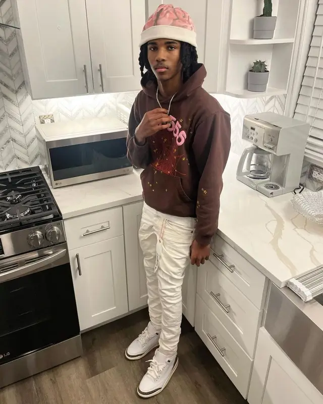 Lil Darius outfit in Spider Worldwide, Purple Brand, and Jordan, 2022