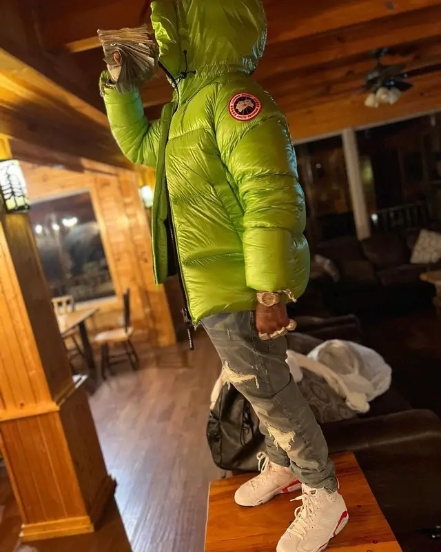 Finesse2tymes outfit in Canada Goose, Amiri, and Chrome Hearts, 2023