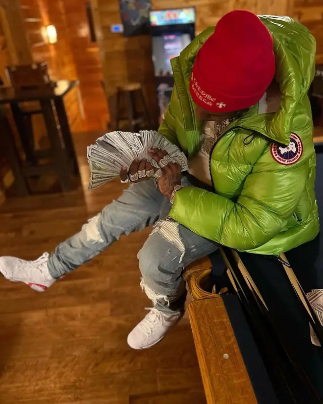 Finesse2tymes outfit in Canada Goose, Amiri, and Chrome Hearts, 2023