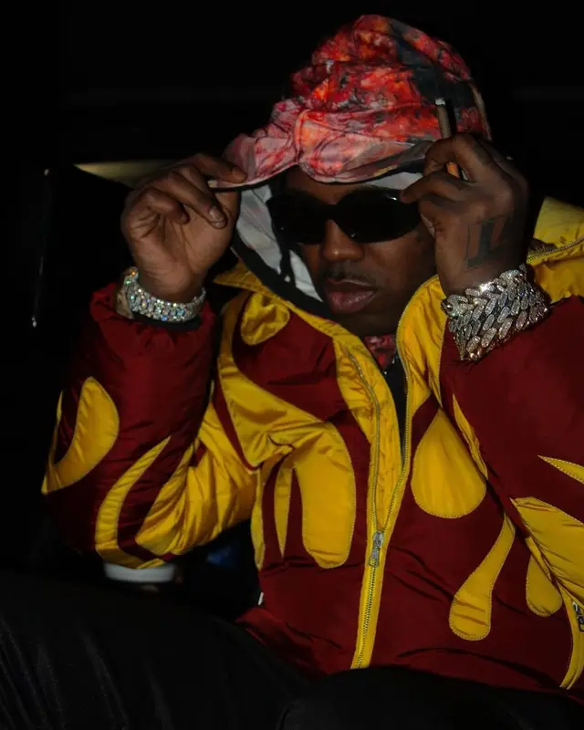 EST Gee outfit in Moncler, Versace, and Palm Angels, 2023