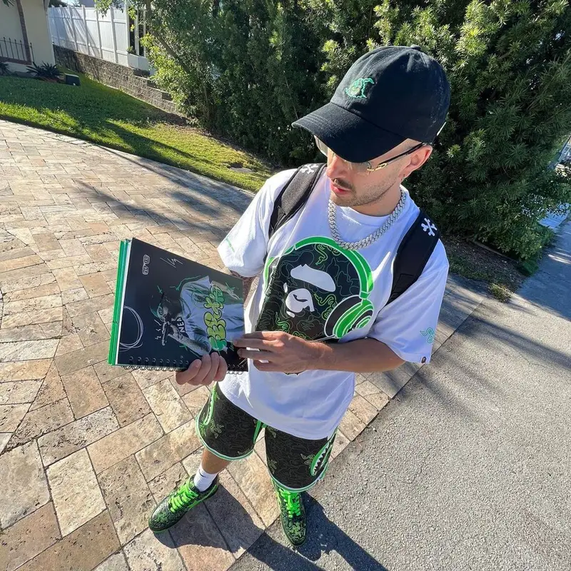 Feid outfit in Bape, Cartier, and Razer, 2023