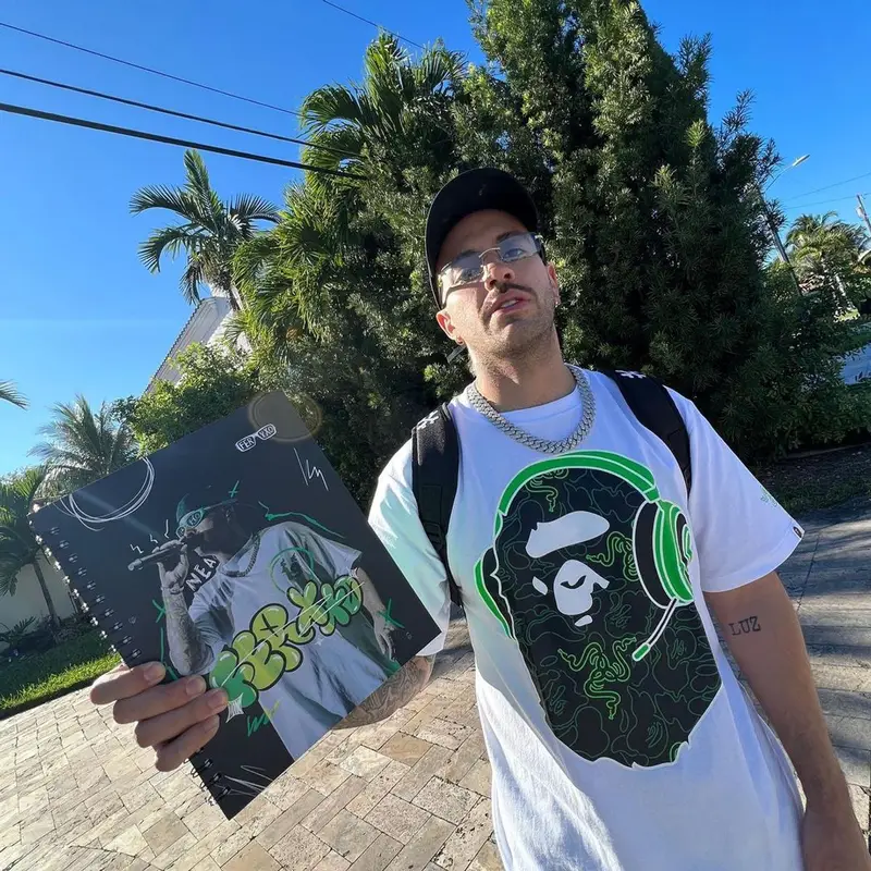 Feid outfit in Bape, Cartier, and Razer, 2023