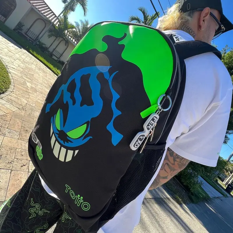 Feid outfit in Bape, Cartier, and Razer, 2023