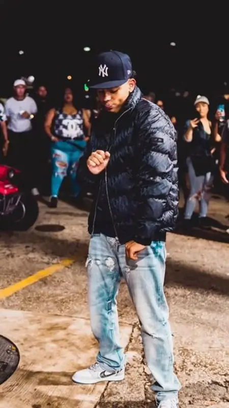Myke Towers outfit in Dior, Nike, and New Era, 2023