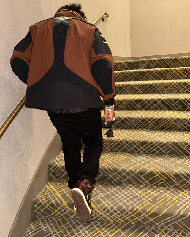 Finesse2tymes outfit in Supreme, Louis Vuitton, and The North Face, 2023