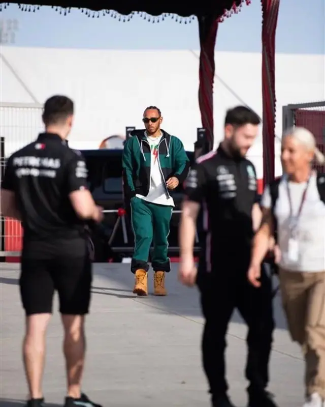 Lewis Hamilton outfit in Louis Vuitton, Gucci, and Nanushka, 2023