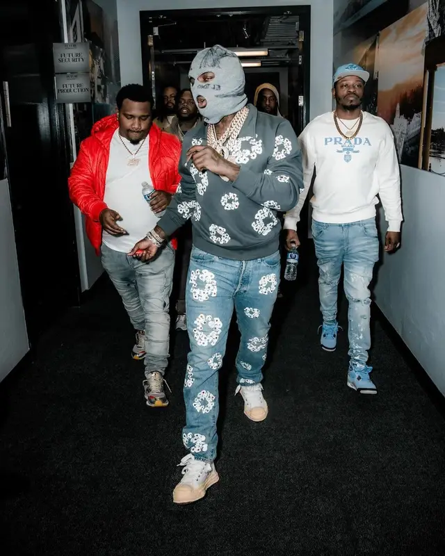 EST Gee outfit in Denim Tears, Levi’s, and Maison Mihara Yasuhiro, 2023