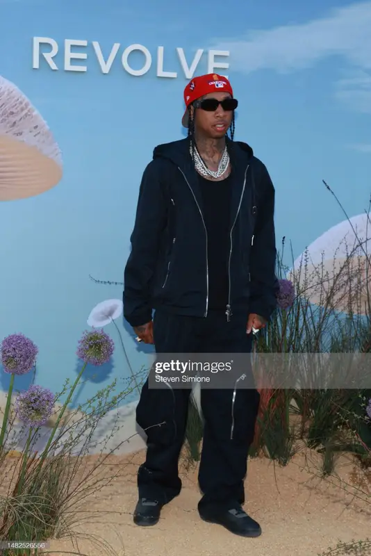 Tyga outfit in Bottega Veneta, Prada, and New Era, 2023