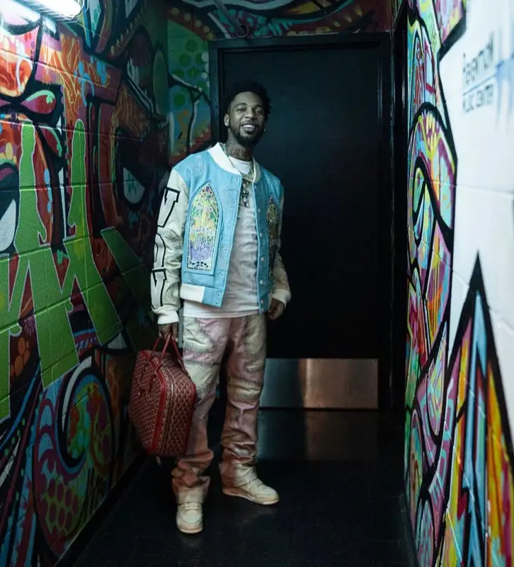 Key Glock outfit in Who Decides War, Nike, and Goyard, 2023