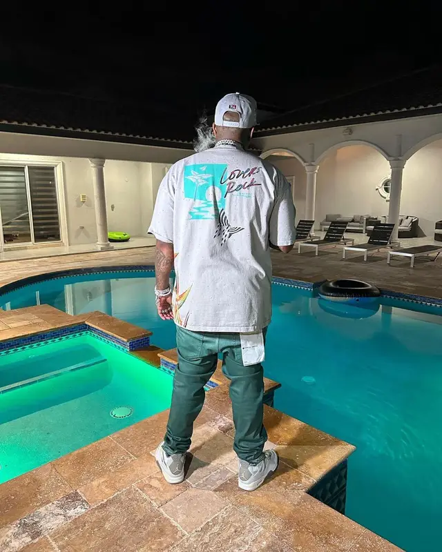Finesse2tymes outfit in Paper Planes, Purple Brand, and Jordan, 2023