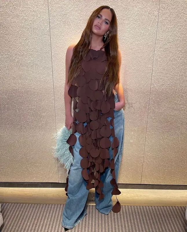 Chrissy Teigen outfit in A.W.A.K.E. Mode, Agolde, and Givenchy, 2023