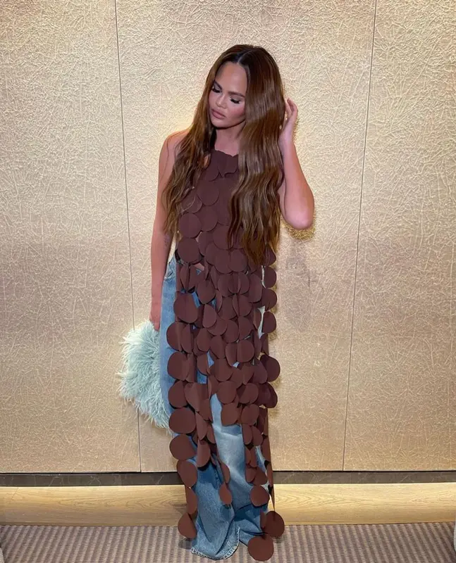 Chrissy Teigen outfit in A.W.A.K.E. Mode, Agolde, and Givenchy, 2023