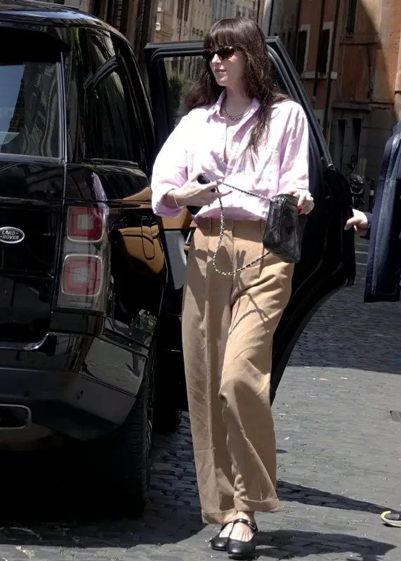 Dakota Johnson outfit in The Row, Oliver Peoples, and Khaite, 2023