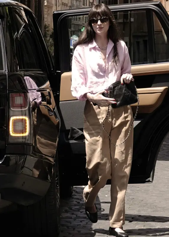 Dakota Johnson outfit in The Row, Oliver Peoples, and Khaite, 2023