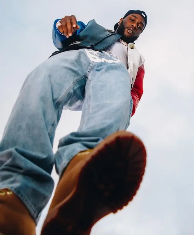 Burna Boy outfit in Avirex, IceCream, and New Era, 2023