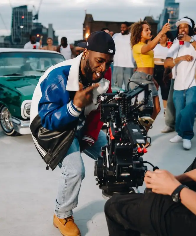 Burna Boy outfit in Avirex, IceCream, and New Era, 2023