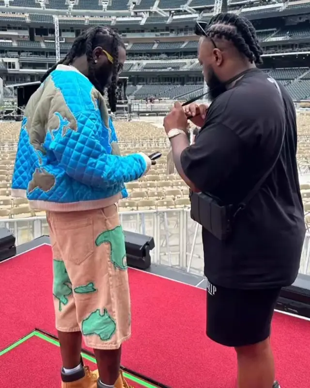 Burna Boy outfit in Who Decides War, Timberland, and New York Mets, 2023
