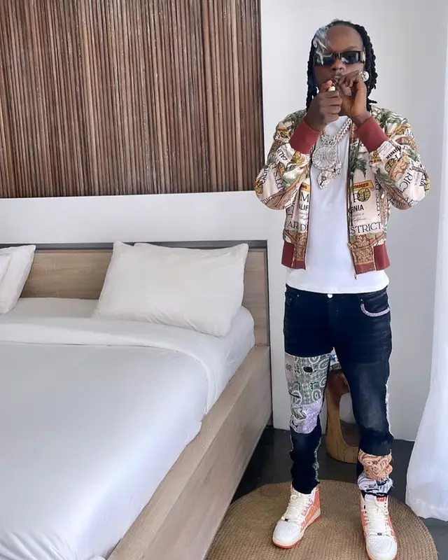 Naira Marley outfit in Amiri and Camilla, 2023