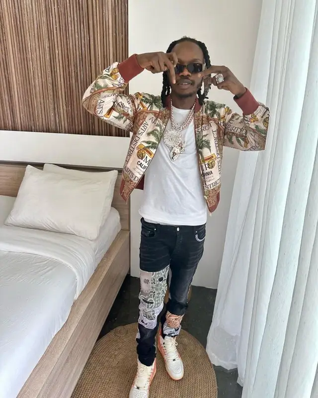 Naira Marley outfit in Amiri and Camilla, 2023