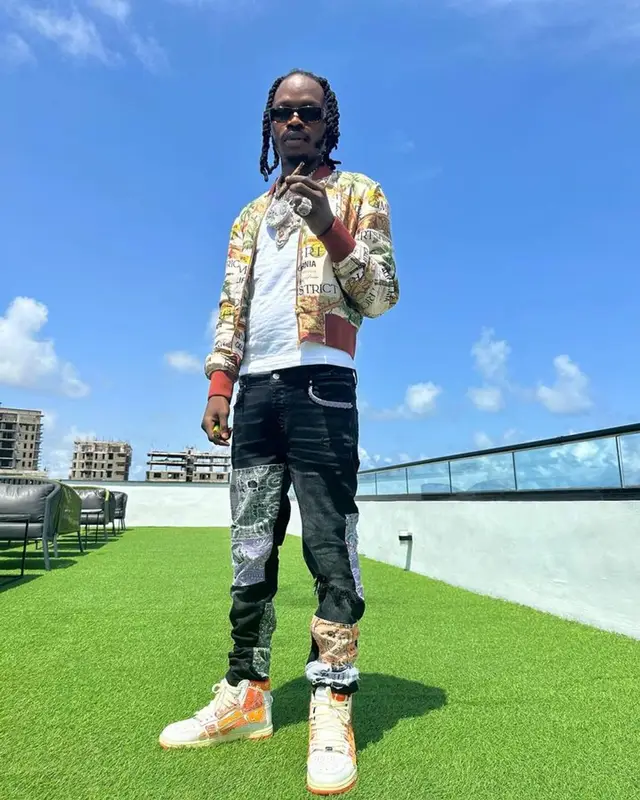 Naira Marley outfit in Amiri and Camilla, 2023