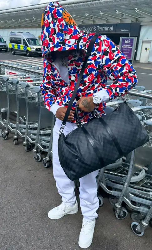 Fivio Foreign outfit in Bape, Louis Vuitton, and Swatch, 2023