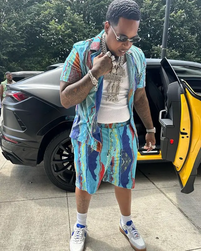 Finesse2tymes outfit in Coogi, Nike, and Cartier, 2023
