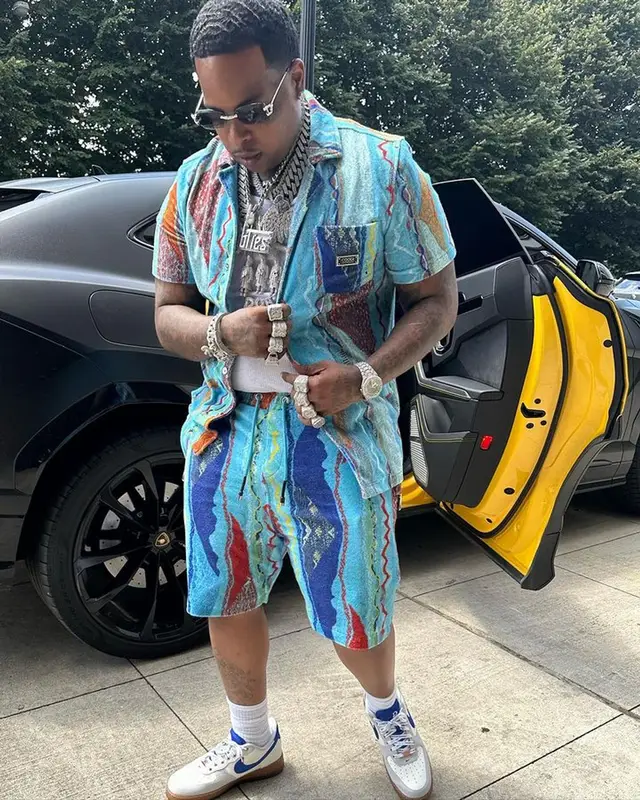 Finesse2tymes outfit in Coogi, Nike, and Cartier, 2023