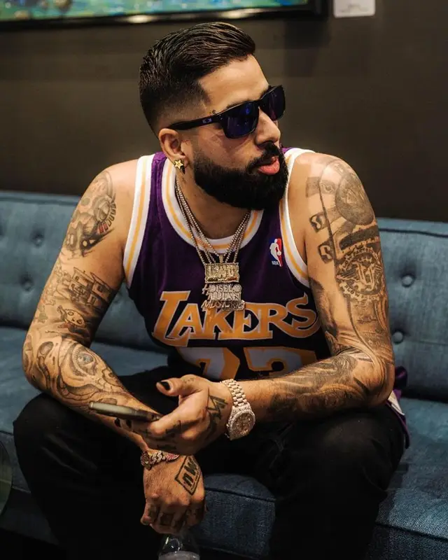 DJ Luian outfit in Mitchell & Ness, Amiri, and Oakley, 2023