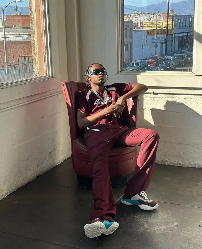Lil Tjay outfit in Louis Vuitton, Camper, and Bottega Veneta, 2023