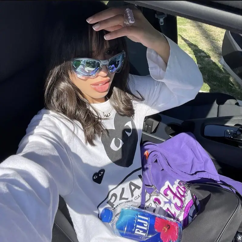 Dina Ayada outfit in Comme Des Garcons, Prada, and Oakley, 2023