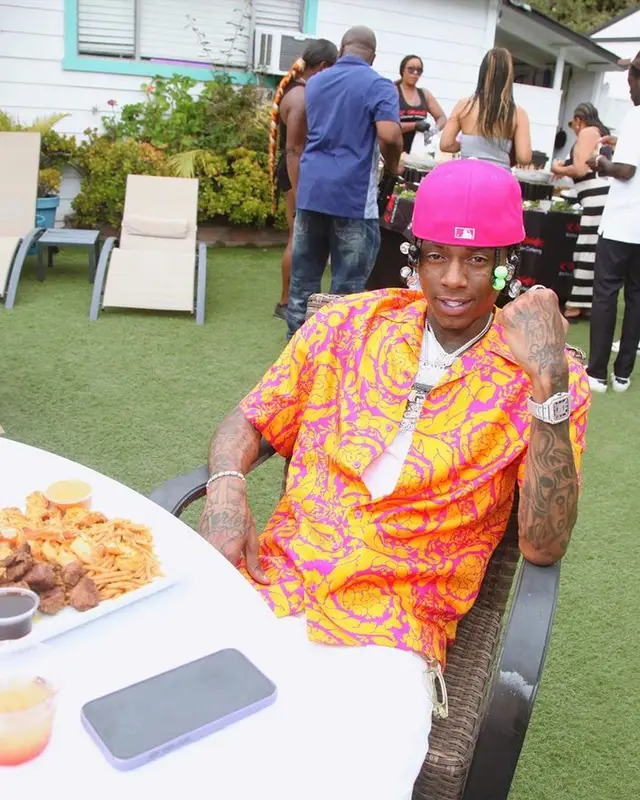 Soulja Boy outfit in Versace and Purple Brand, 2023