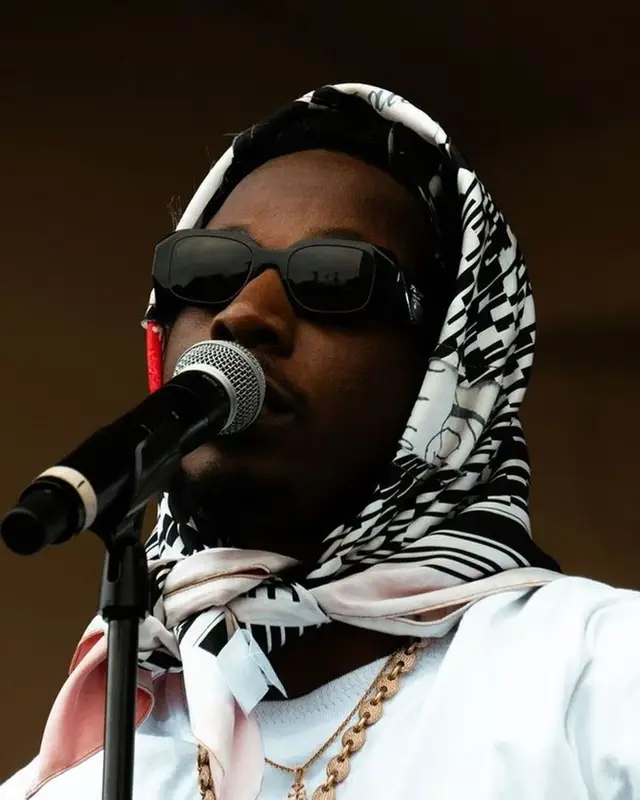 Joey Badass outfit in Vidin Was Taken, Maison Mihara Yasuhiro, and Prada, 2023