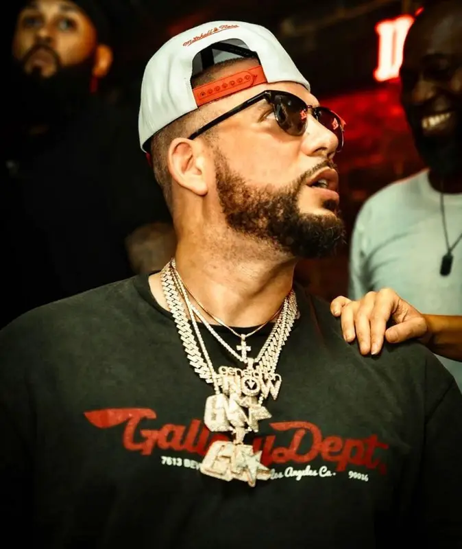 DJ Drama outfit in Gallery Dept., Tom Ford, and Mitchell & Ness, 2023