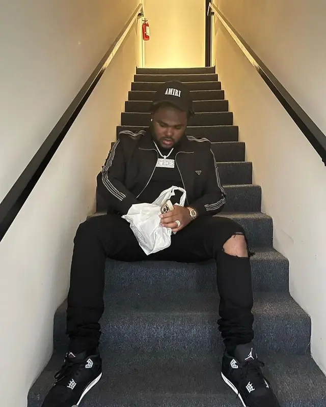 Tee Grizzley outfit in Prada, Purple Brand, and Amiri, 2023
