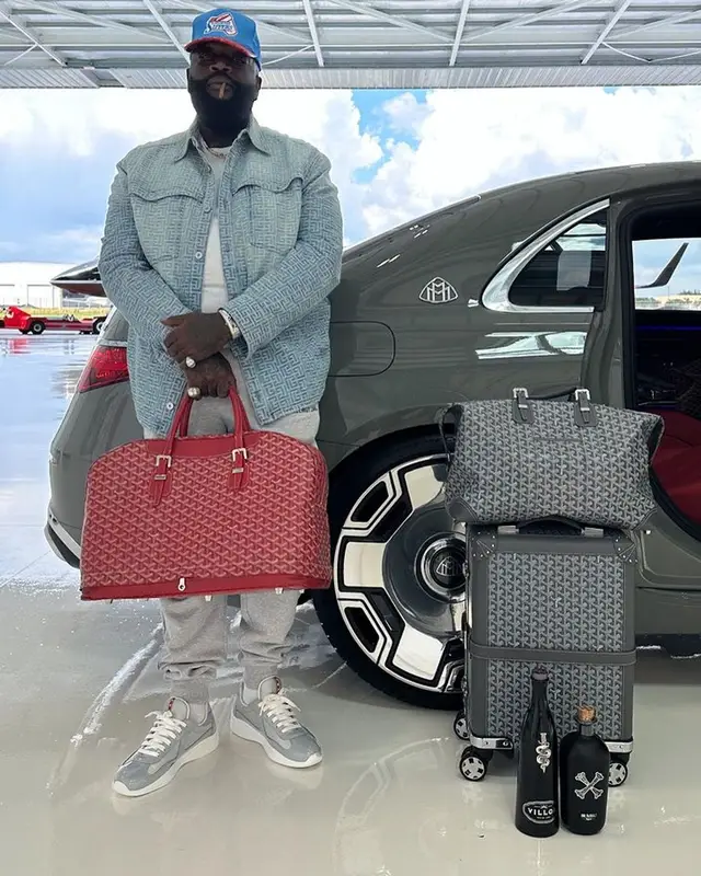 Rick Ross outfit in Balmain, Prada, and Goyard, 2023