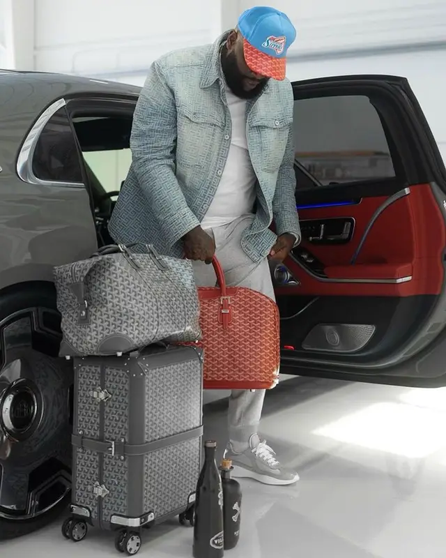 Rick Ross outfit in Balmain, Prada, and Goyard, 2023
