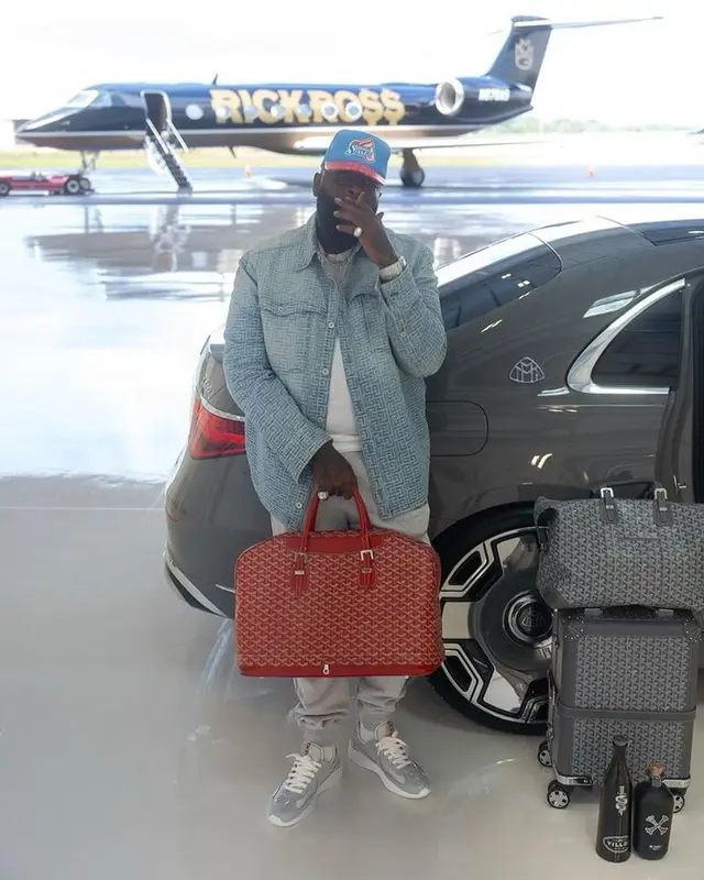 Rick Ross outfit in Balmain, Prada, and Goyard, 2023