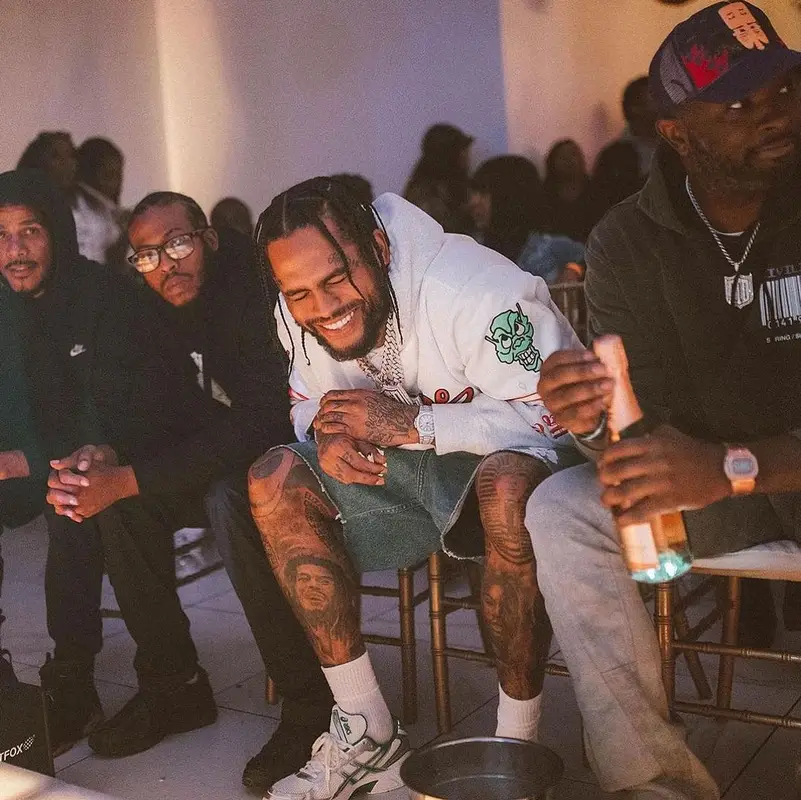Dave East outfit in Supreme, Denim Tears, and Mitchell & Ness, 2023