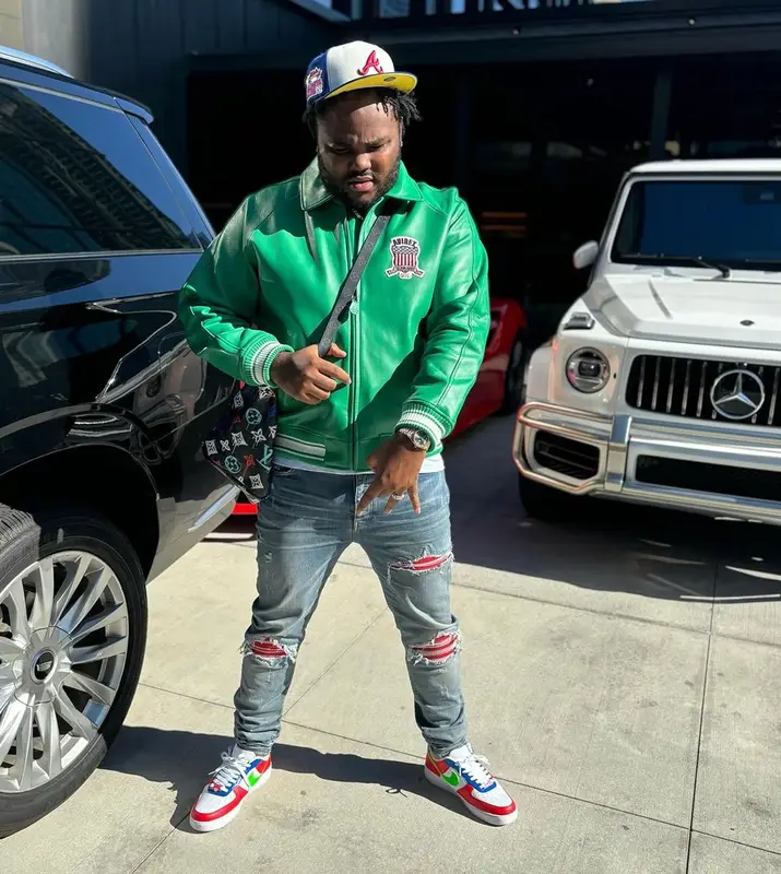 Tee Grizzley outfit in Avirex, Louis Vuitton, and New Era, 2023