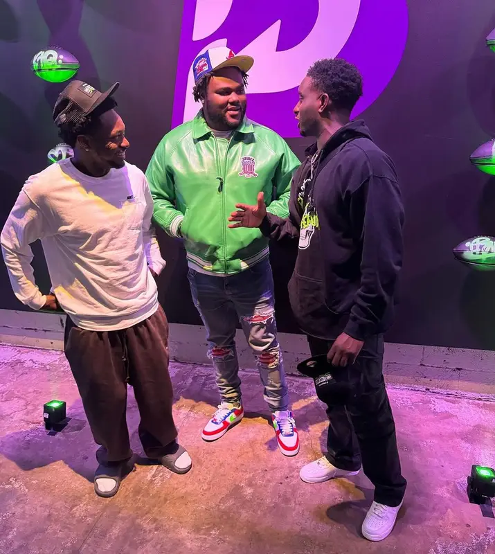 Tee Grizzley outfit in Avirex, Louis Vuitton, and New Era, 2023