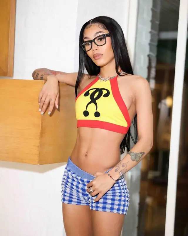Coi Leray outfit in Moschino, Crocs, and Ray-Ban, 2023
