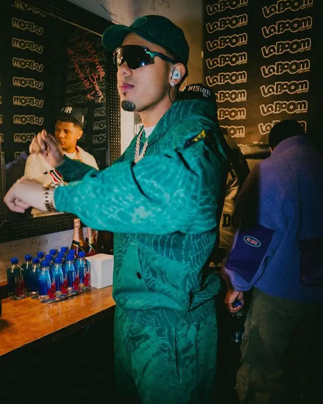 Myke Towers outfit in Oakley, Supreme, and Stone Island, 2023