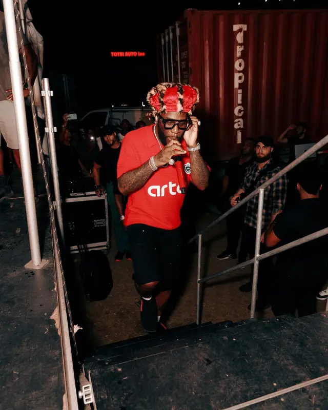 Burna Boy outfit in Arte Antwerp, Clarks, and Louis Vuitton, 2024