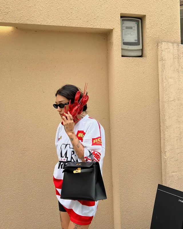 Peggy Gou outfit in Martine Rose, Hermes, and Prada, 2024